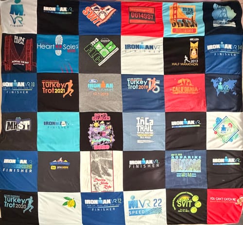 Customer's Project Repat T-Shirt Quilt featuring a patchwork of colorful marathon and sporting event t-shirts.