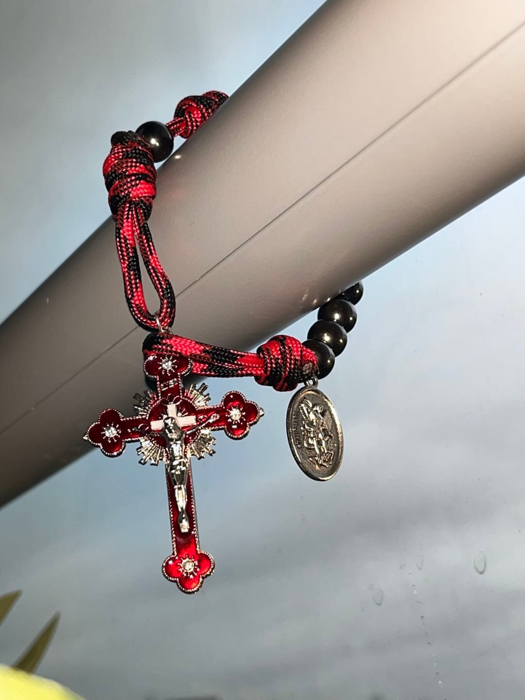 Customer photo review of Solacebeads Gunmetal Bead Car Rosary & Red Enamel Crucifix: Rooted In St. Michael Protection