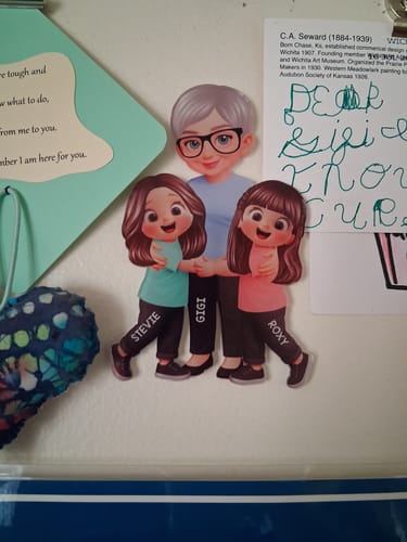 Customer's personalized acrylic fridge magnet showing an adult with two children on a white refrigerator surface.