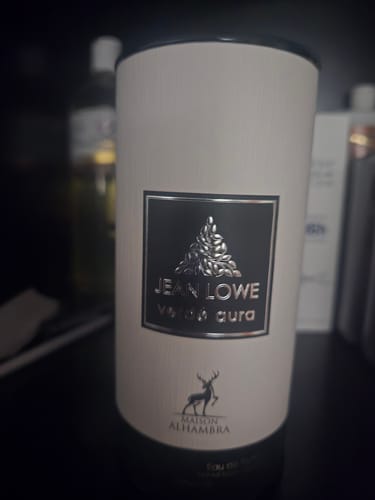 Customer's Jean Lowe Verde Aura perfume box, featuring a central black label with a silver deer logo and lettering.