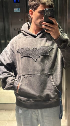 Customer's Batman Stealth Hoodie in grey with a prominent tonal bat emblem on the chest.