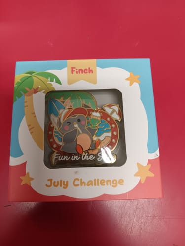 Customer's Fun in the Sun Pin inside its colorful July Challenge packaging box