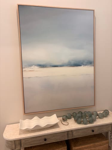 Customer's Misty Morning Canvas Art in a light wood frame, hung above a console table in an entryway.