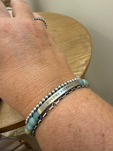 Customer wearing the stainless steel silver STACKER bracelet stacked with a 'Forever Friends' and beaded bracelet.