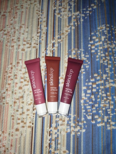 Customer's three Peptide Lip Glaze products in the shades Sandalwood, Teddy Kiss, and Deep Berry.
