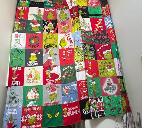 Customer's large Project Repat T-Shirt Quilt made from many colorful t-shirts with different Grinch designs.
