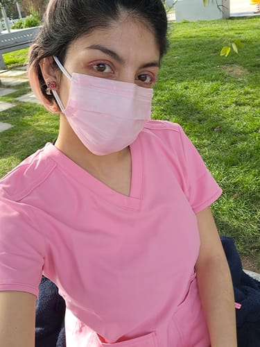 Customer's pink MedCouture MC2411 top, worn outdoors with a matching mask.