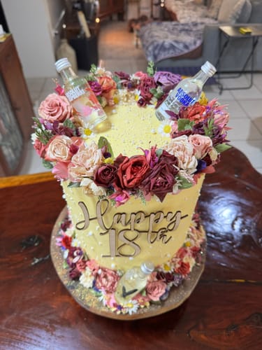 Reviewer's yellow birthday cake decorated with colorful flowers and Green Goddess Flowerfetti.