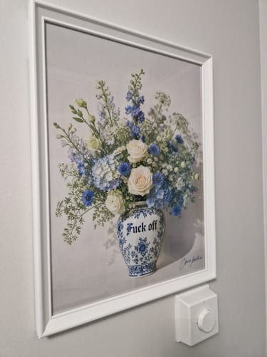 Customer's 'Boundaries' art print, in a white frame, hanging on a hallway wall next to a light switch.
