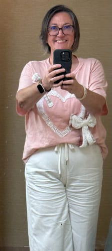 Reviewer taking a mirror selfie wearing the high waist white featherweight palazzo pants.