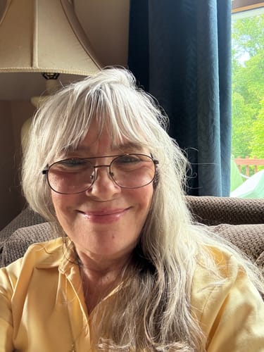 Reviewer smiling, showing her glowing skin after using the Micro Infusion System.