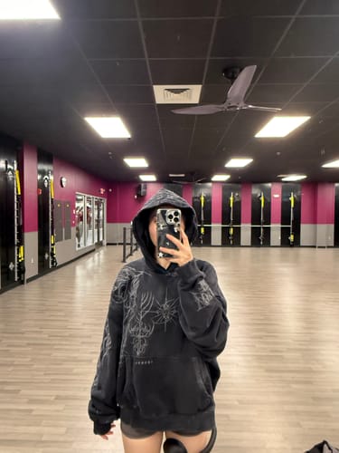 Close-up of the reviewer wearing the Cyberpunk Hoodie with the hood up, showing the graphic print.