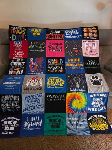 Customer's colorful Project Repat T-Shirt Quilt, made from a principal's career t-shirts, draped over a sofa.