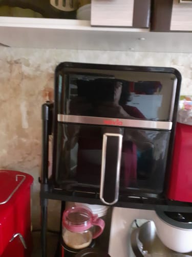 A customer's black Air Fryer Novio StonePro with a glossy finish, shown on a kitchen shelf.