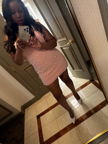 Angled mirror selfie of the reviewer in the pink Knit Pearl Mini Dress, showing the pearl straps.