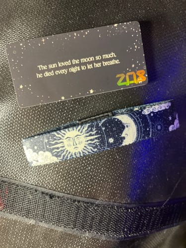 Customer's Sol & Luna Bracelet with a detailed sun and moon design, shown next to its accompanying quote card.