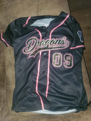 Customer's custom black baseball jersey with pink trim, featuring 'Dragons' and the number '09' on the front.