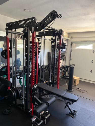Customer's RitFit LPM1 Lat Pulldown and Leg Holder attachment bundle installed on the M1 PRO rack in a home gym.