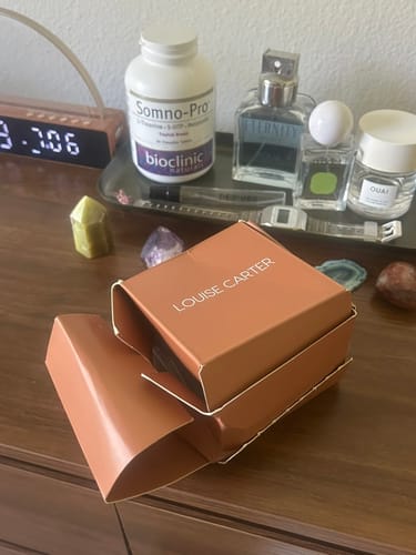 Customer's damaged and misshapen Louise Carter box for the Kauai Choker, sitting open on a wooden surface.