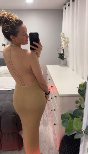 Reviewer showing the open back detail of the Knit Halter Open Back Dress in a mirror selfie.