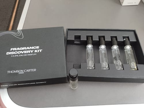 Reviewer's open Fragrance Discovery Kit, showing the black box with four vials and one vial set outside.