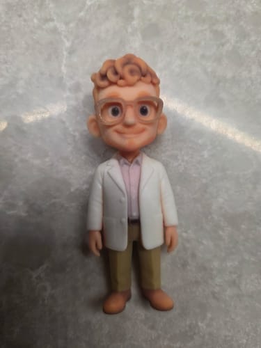 Customer's custom 3D figurine of a man with curly hair and glasses, wearing a white jacket and khaki pants.