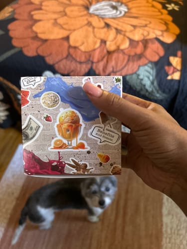 Customer holding the decorative packaging box for their Body Glaze product.