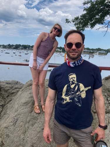 Customer wearing the dark Roosevelt Rock T-Shirt with a clear graphic of Roosevelt playing a guitar outdoors.