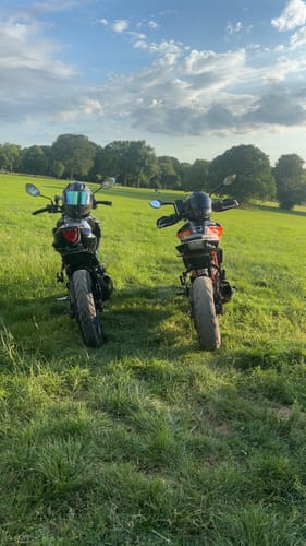 A customer's Suzuki GSXS 125, showing the rear with the minimal tail tidy, parked in a grassy field.