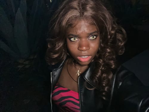 Customer wearing striking Cosplay Avatar yellow Colored Contact Lenses for a Halloween costume in a dark setting.