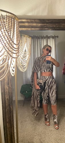 Reviewer's mirror selfie in a zebra-print outfit with a sheer chiffon cover-up.