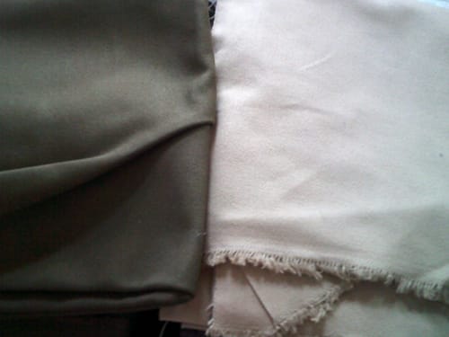 Customer's side-by-side comparison of olive green and sand-colored Extra Heavyweight Cotton Canvas fabric pieces.