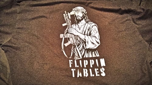 Customer's brown T-shirt with a graphic of Jesus holding a rifle and the text Flippin Tables printed below.
