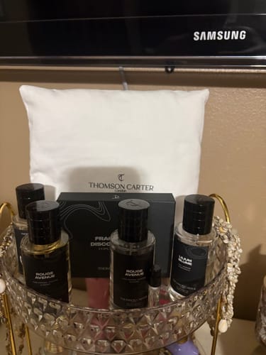 Customer's collection of Rouge Avenue and other fragrance bottles arranged on a tiered decorative tray.