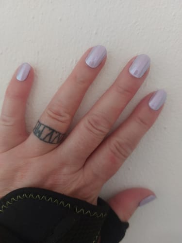 Customer's hand showing Lavender Chrome UV Gel nail wraps with a smooth, shiny finish.