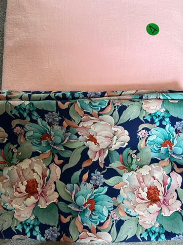 Customer's Spring Whisper Viscose Twill Fabric in floral print, with a plain pink fabric swatch above it.