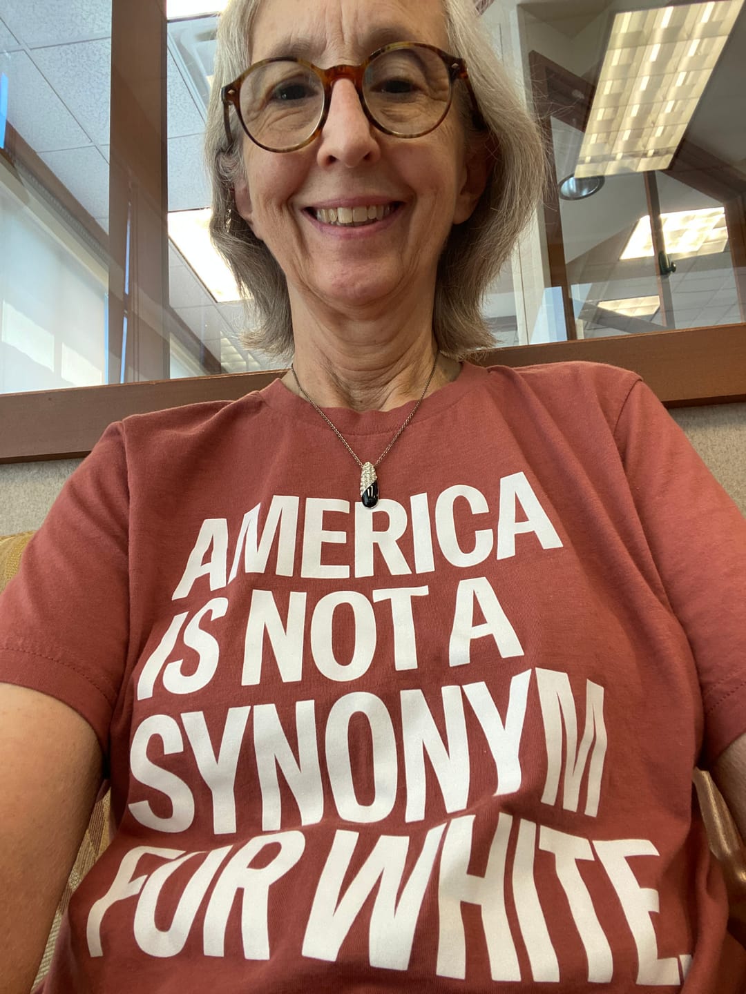 Customer photo review of America Is Not a Synonym for White Unisex Tee