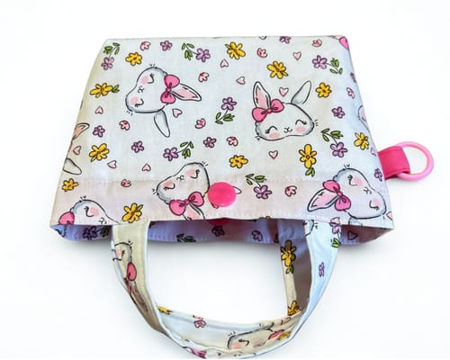 Customer's tote bag made with Bunny Blossom Rose & Hubble cotton poplin fabric, viewed from above.