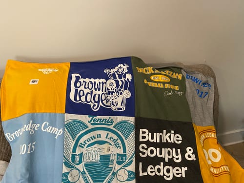 Customer's Project Repat T-Shirt Quilt featuring various colorful t-shirt squares with camp and sports logos.