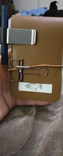 Reviewer's tan Pocket Archive held in hand, secured with an elastic band and a metal clip, featuring a small fish label.