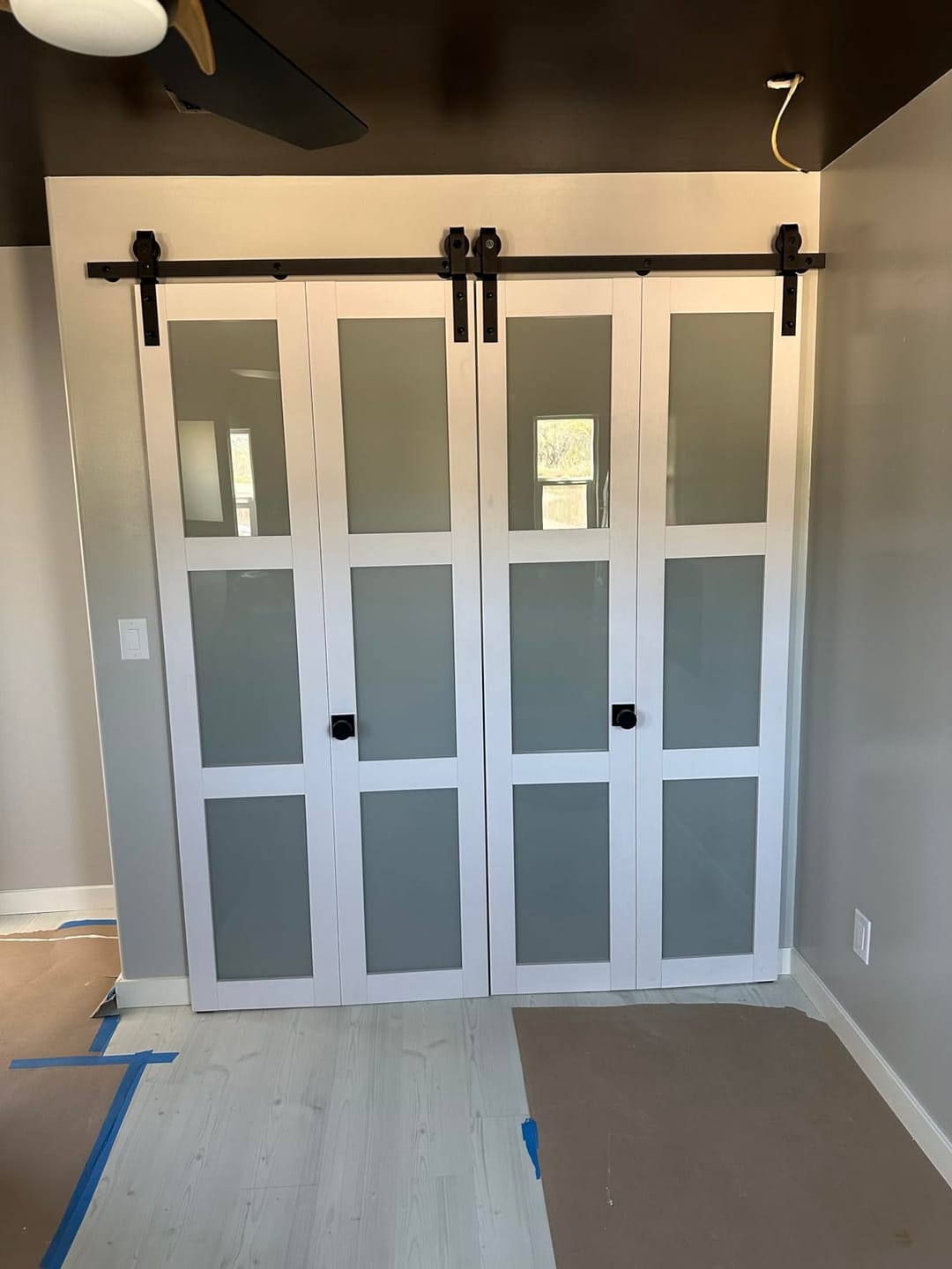 Customer photo review of TENONER White MDF 3-Lite Tempered Frosted Glass Bi-Fold Sliding Barn Door for Closet, Bedroom - Space-Saving and Pre-Drilled