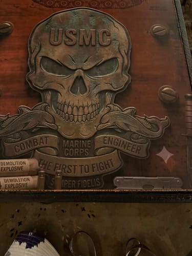 Customer's Custom Cornhole Board Wrap with USMC skull design, explosive graphics, and tactical details in a close-up.