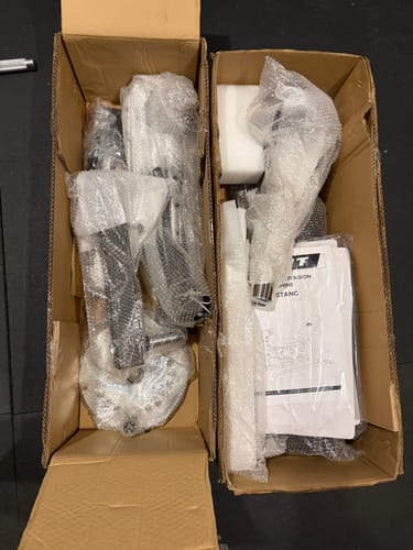 Customer's RitFit Mustang PRO Leg Extension Curl Machine components packed in two cardboard shipping boxes.
