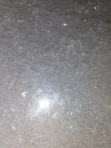 Customer's blurry, close-up view of a grey surface.