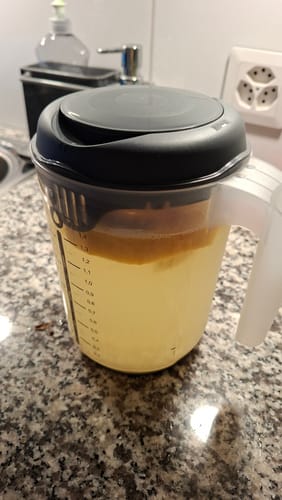Customer's Wasserkefir fermenting in a clear plastic measuring jug on a kitchen counter.