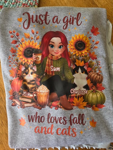 Customer's gray personalized sweatshirt featuring a girl, sunflowers, pumpkins, and two cats named Mia and Charlotte.