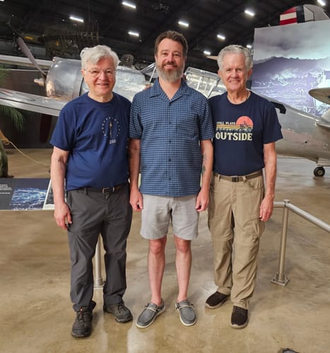 Reviewer's blue Eternal Torch t-shirt worn by a person standing in a museum with aircraft in the background.