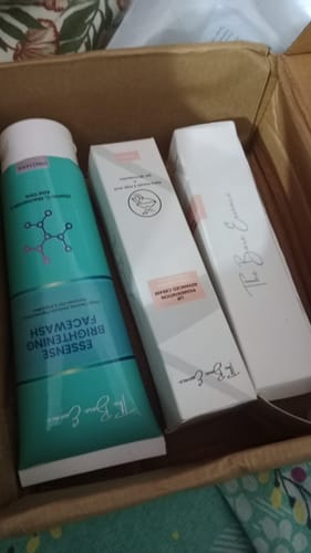Customer's box containing an Essense face wash tube and two boxes of Lip Cream instead of the expected sunblock.