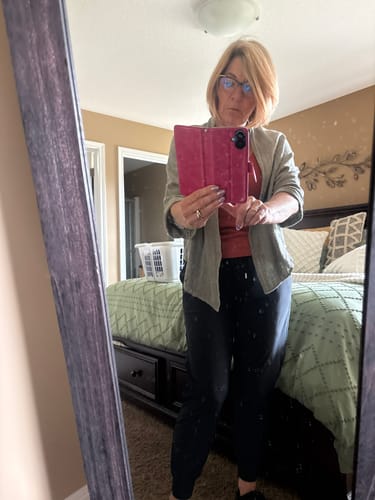 Customer's olive Meo Linen Savona Cardigan worn over a tank top in a bedroom mirror selfie.