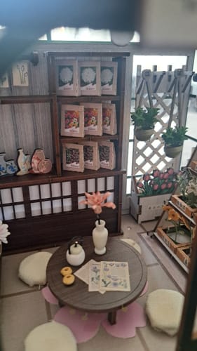 Customer's Sakura Teahouse interior, showing miniature wooden furniture, table setting, and small decorative plants.